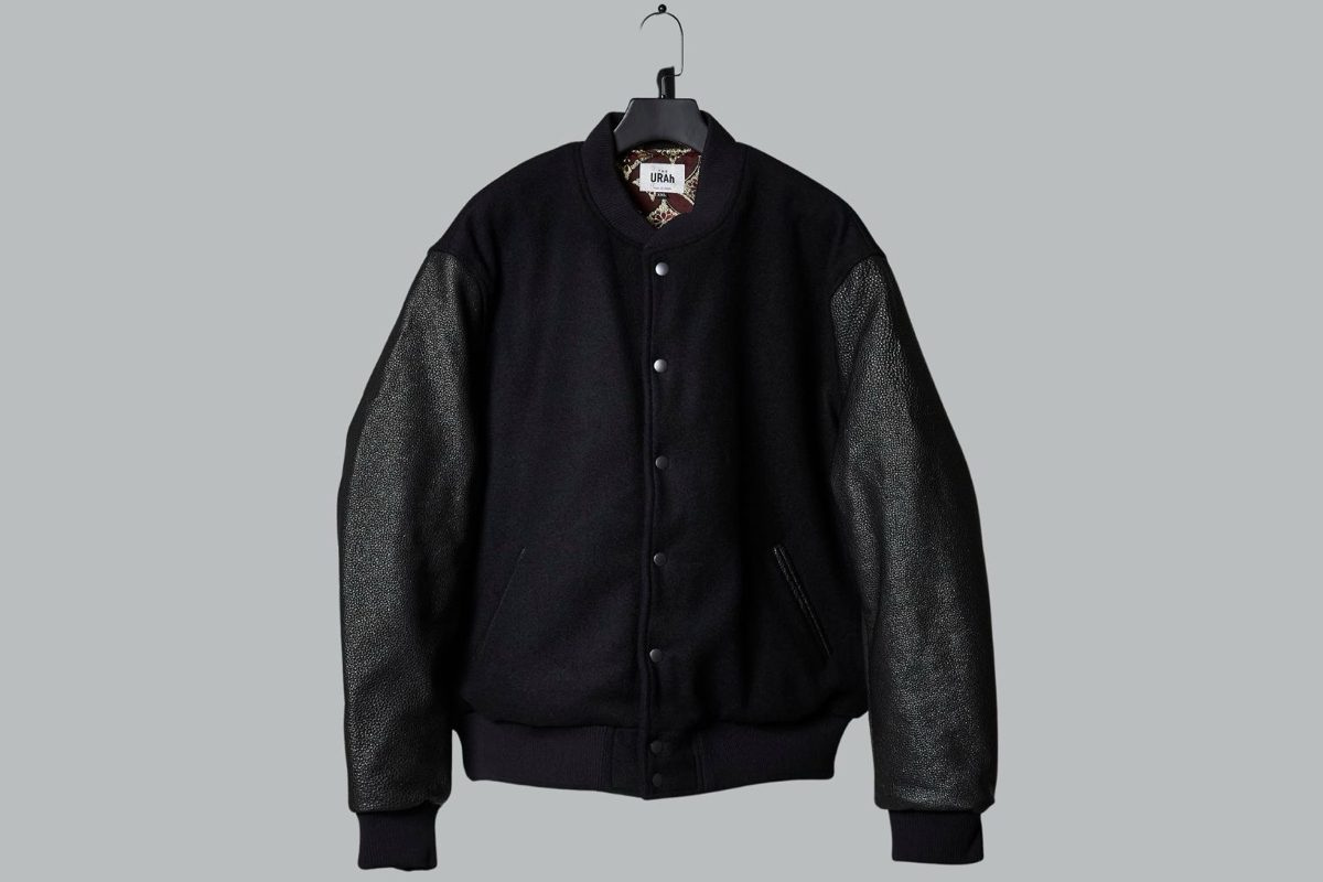 A THE URAh varsity jacket: black wool body with leather sleeves.