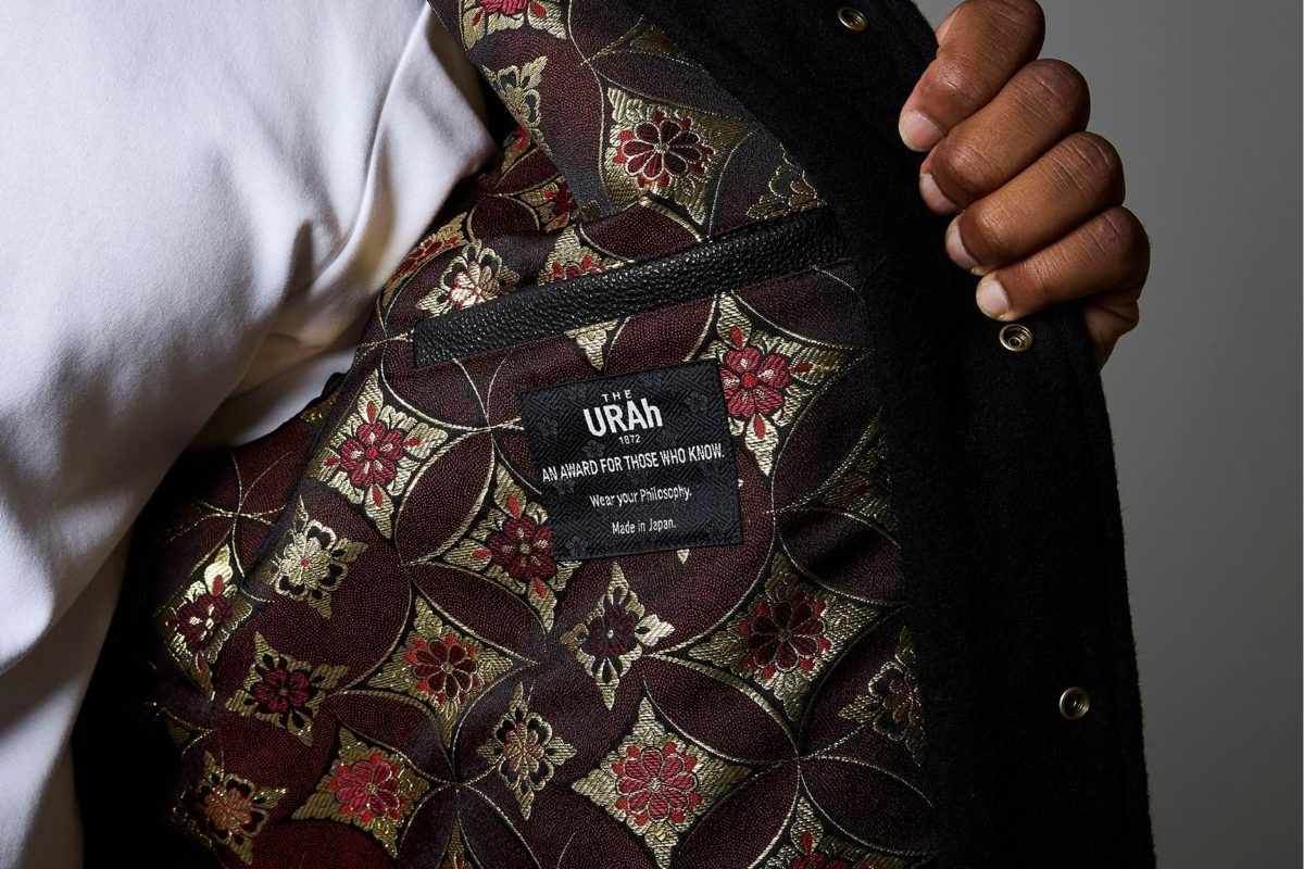 The lining of a THE URAh jacket: gold and deep-red brocade with the brand’s inner label.